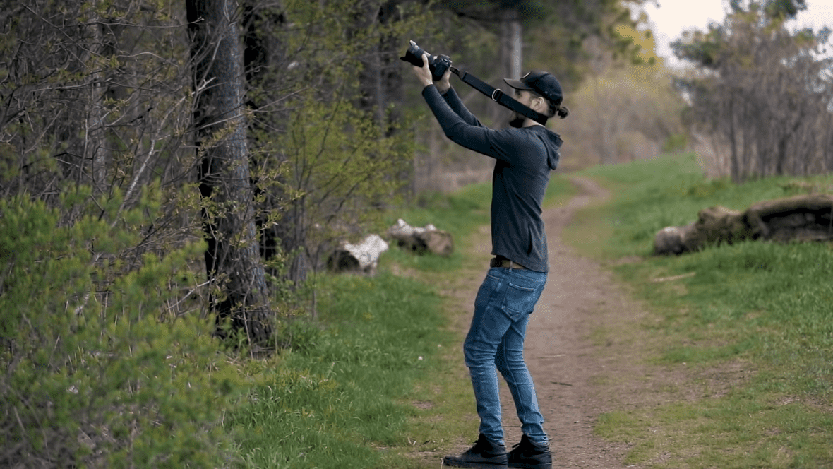 Man positioning his body and taking pictures from Camera