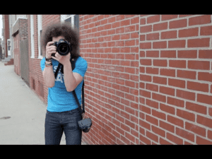 Man holding camera using handgrip and taking photos