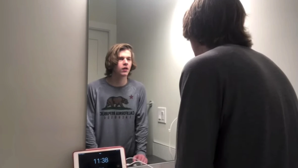 Boy looking him in the mirror